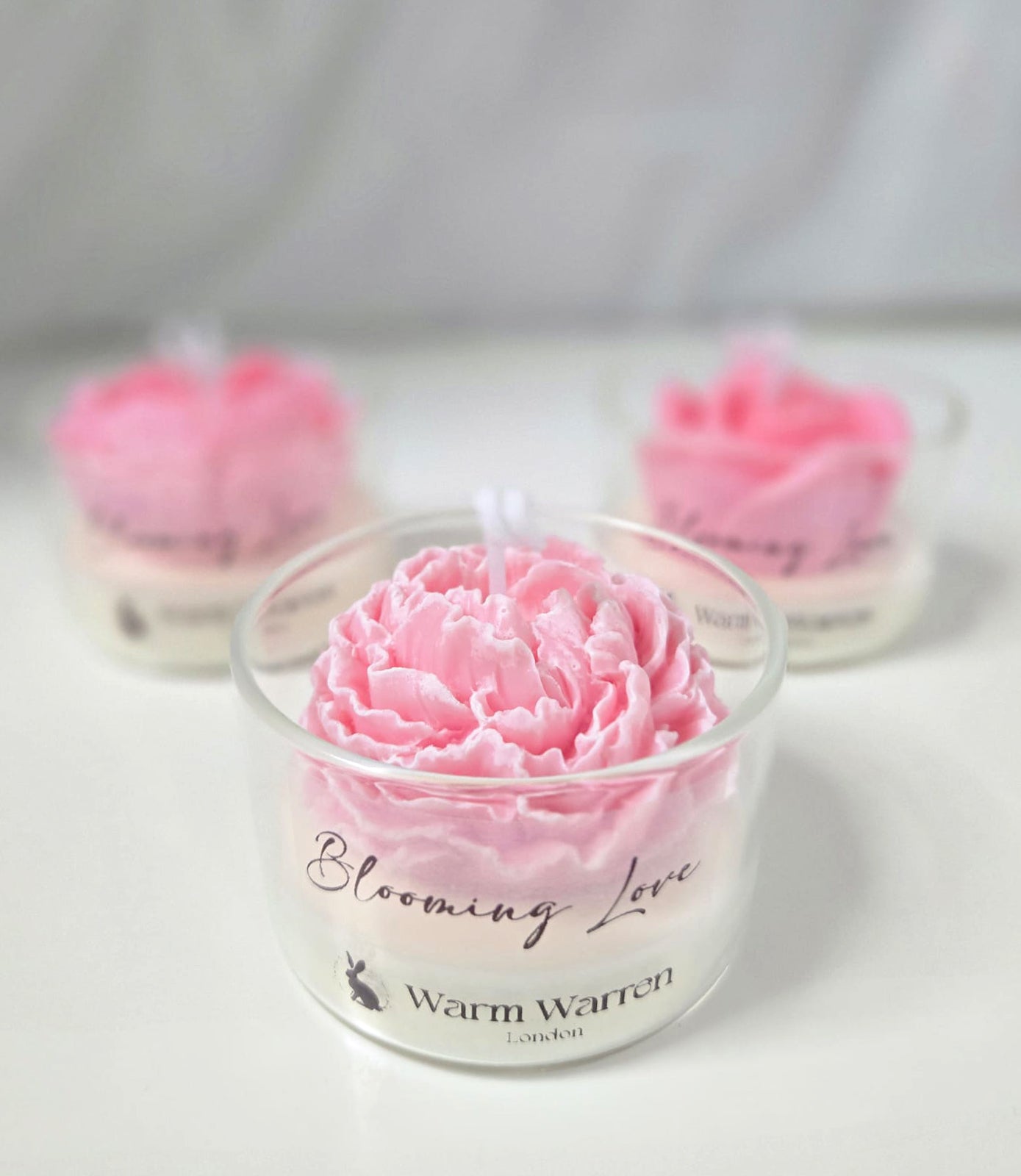 Warm Warren London Blooming Love, handmade soy wax Candle Flower in Glass container peony flower close-up studio photo. Valentines day, mothers day gift set