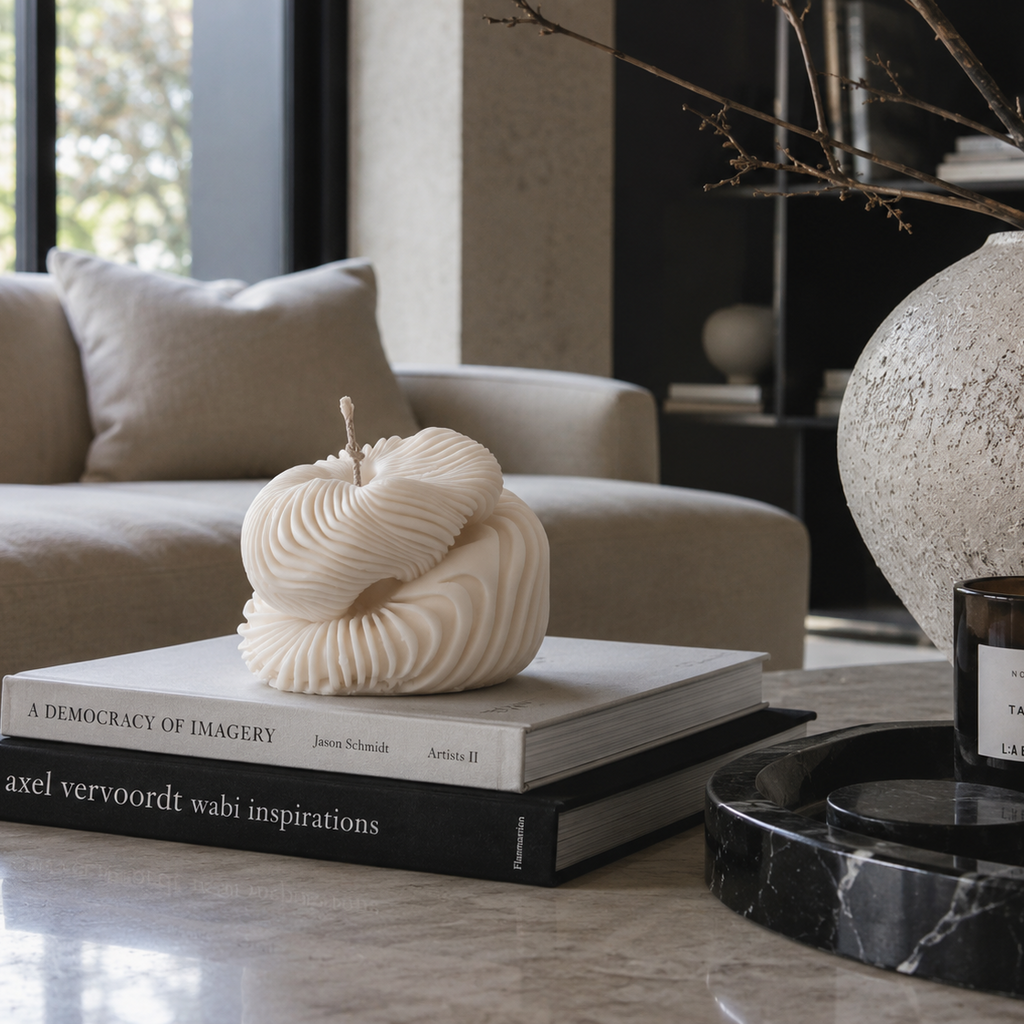 Warm Warren London Handmade Soy wax Ethereal Fold Pillar Candle styled on coffee table books in a minimalist neutral living room