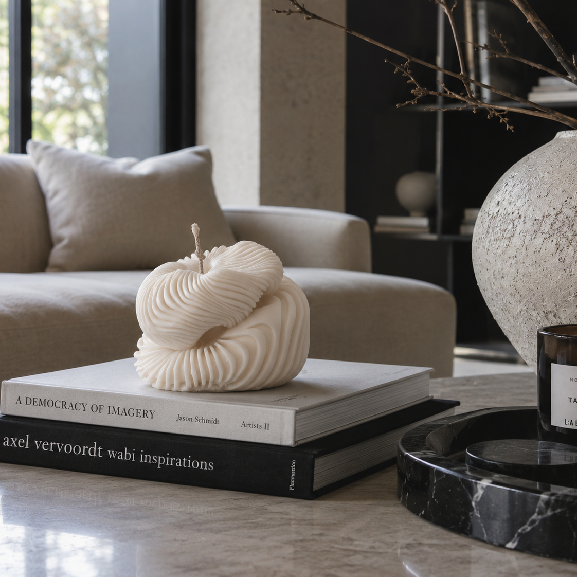 Warm Warren London Handmade Soy wax Ethereal Fold Pillar Candle styled on coffee table books in a minimalist neutral living room