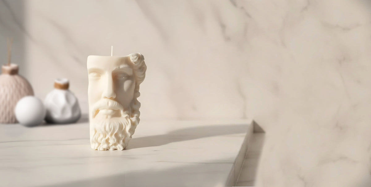 An ivory Zeus sculpture candle in warm afternoon light.