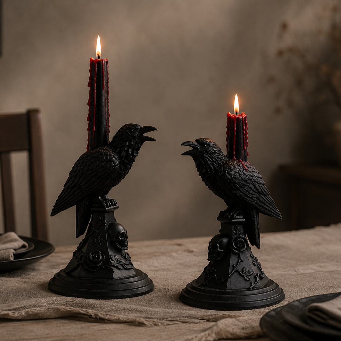 Two handmade black raven candle holders with skull bases displayed on a minimalist Halloween dining table, styled with black bleeding taper candles and gothic décor.