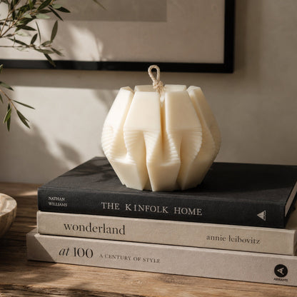 Nexus Pillar Candle in premium natural ivory wax, featuring a modern geometric sculptural design. Hand-poured in London as a luxury decorative candle for contemporary home interiors.