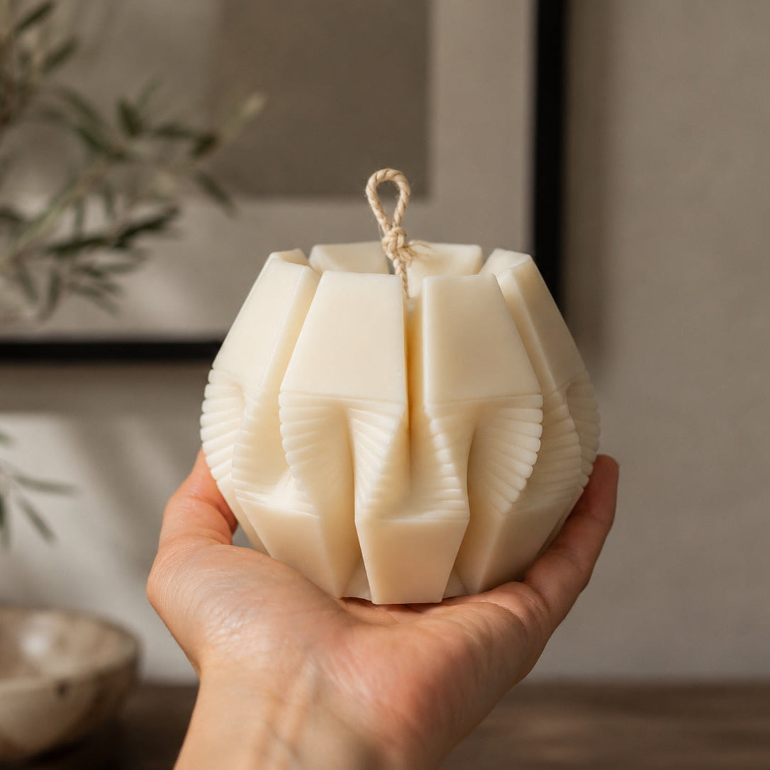 Nexus Pillar Candle in premium natural ivory wax, featuring a modern geometric sculptural design. Hand-poured in London as a luxury decorative candle for contemporary home interiors.