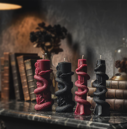 On use in book shelf snake-shaped candle with roses on a light gray background. Venom Rose Pillar - Gothic Collection Soy Wax Handmade Candle Halloween