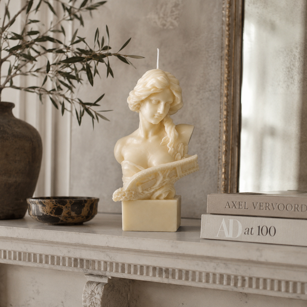 Lyra Sculpture Candle handcrafted ivory wax bust featuring a classical female sculpture holding a lyre, photographed on a premium neutral studio background.