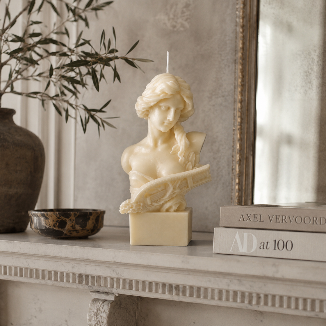 Lyra Sculpture Candle handcrafted ivory wax bust featuring a classical female sculpture holding a lyre, photographed on a premium neutral studio background.