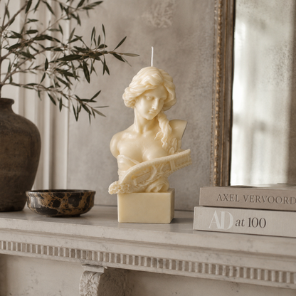 Lyra Sculpture Candle handcrafted ivory wax bust featuring a classical female sculpture holding a lyre, photographed on a premium neutral studio background.