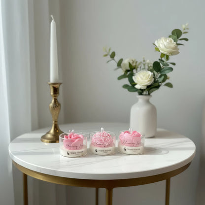 Three pink Flower Soy Wax Handmade candles in glass holders on a marble table. Its interior use of Blooming Love Candle Gift Set - 3pcs