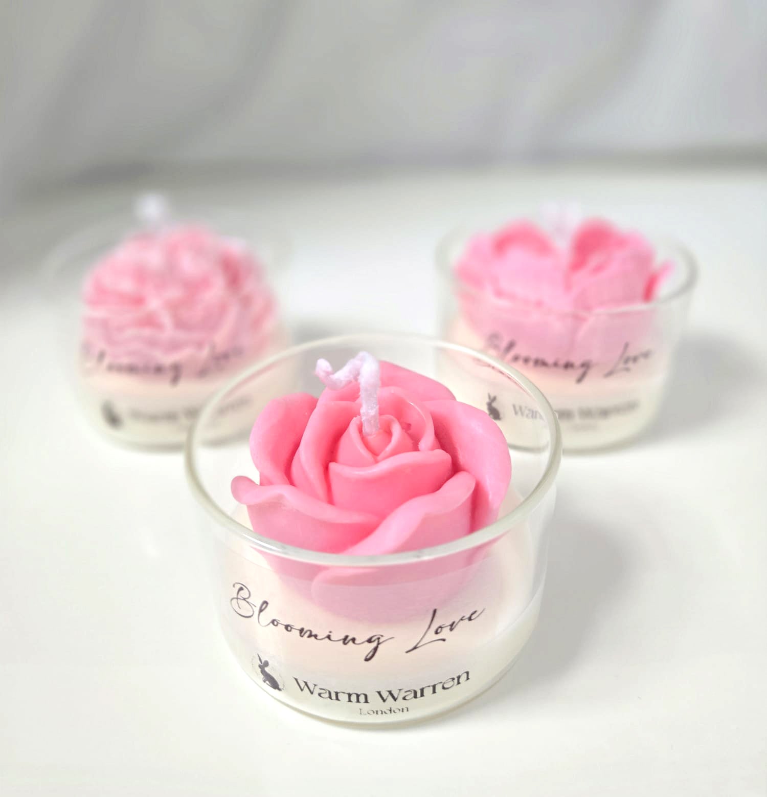 Rose and Peony shaped soft pink Flower Soy Wax Handmade candles in glass holders on a studio. Its interior use of Blooming Love Candle Gift Set - 3pcs